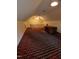 Large attic space with sloped ceilings, desk, and bright lighting, offering potential for various uses at 3300 Barnsley Ln, Raleigh, NC 27604