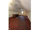 Spacious attic room with a desk and natural light, offering versatile use for storage or hobbies at 3300 Barnsley Ln, Raleigh, NC 27604