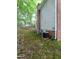 Back of home featuring brick and vinyl siding, AC units, and a wooded backyard at 3300 Barnsley Ln, Raleigh, NC 27604
