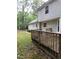 Spacious backyard with a wooden deck and lush green surroundings at 3300 Barnsley Ln, Raleigh, NC 27604