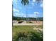View of baseball field through a metal gate surrounded by lush greenery at 3300 Barnsley Ln, Raleigh, NC 27604