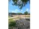 View of a baseball field with metal fences and bleachers under a blue sky at 3300 Barnsley Ln, Raleigh, NC 27604