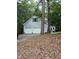 Spacious two-car garage complemented by a well-manicured lawn and surrounded by lush greenery at 3300 Barnsley Ln, Raleigh, NC 27604