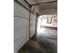 Open garage featuring concrete floor and a brick wall at 3300 Barnsley Ln, Raleigh, NC 27604