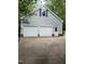 Well-maintained two-car garage featuring a clean design, a small window, and a neat driveway at 3300 Barnsley Ln, Raleigh, NC 27604