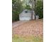 Detached two-car garage set among trees, featuring a clean design and a well-maintained driveway at 3300 Barnsley Ln, Raleigh, NC 27604