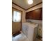 Well-equipped laundry area featuring washer, dryer, cabinets, and exterior access at 3300 Barnsley Ln, Raleigh, NC 27604
