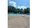Outdoor swimming pool with lounge chairs and umbrellas under a sunny sky at 3300 Barnsley Ln, Raleigh, NC 27604