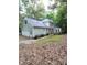 Spacious home exterior featuring a detached garage, backyard deck, and lush greenery, perfect for outdoor living at 3300 Barnsley Ln, Raleigh, NC 27604