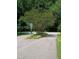 Landscaped community entrance with small trees, greenery, and a street sign at 3300 Barnsley Ln, Raleigh, NC 27604