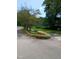 Community entrance sign surrounded by greenery and flowers on a sunny day at 3300 Barnsley Ln, Raleigh, NC 27604