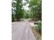 View of the quiet street leading to the home with mature trees at 3300 Barnsley Ln, Raleigh, NC 27604