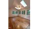 Bright sunroom with skylights, multiple windows, and hardwood floors offers natural light at 3300 Barnsley Ln, Raleigh, NC 27604