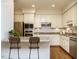 Virtually staged eat-in kitchen features granite countertops and stainless appliances at 3339 Ridgecrest Ct, Raleigh, NC 27607