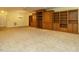 Expansive living room featuring built-in storage, carpet flooring, and chandelier lighting at 3339 Ridgecrest Ct, Raleigh, NC 27607