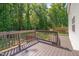 A view of a back deck with a wooden railing overlooking the backyard at 40 Otter Ct, Youngsville, NC 27596