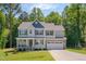 Charming two-story home with a combination stone and siding exterior and well-manicured lawn at 40 Otter Ct, Youngsville, NC 27596
