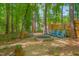 Cozy backyard fire pit area with Adirondack chairs, perfect for gatherings and enjoying the outdoors at 40 Otter Ct, Youngsville, NC 27596