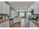 Modern kitchen with stainless steel appliances, granite countertops, and a view to the living room at 40 Otter Ct, Youngsville, NC 27596