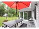 Outdoor back deck with a red umbrella, table with benches, and chairs, perfect for entertaining guests at 404 Denton St, Durham, NC 27713
