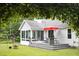 Backyard featuring an outdoor deck with patio furniture and a treed area, creating a private and relaxing oasis at 404 Denton St, Durham, NC 27713
