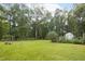 Expansive backyard showcasing lush green grass, mature trees, and a peaceful outdoor setting at 404 Denton St, Durham, NC 27713