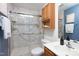 Bathroom features a walk-in shower, oak vanity, and grab bars at 404 Denton St, Durham, NC 27713