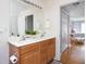 Bathroom with double vanity, wood cabinets, and connecting bedroom access at 404 Denton St, Durham, NC 27713