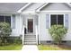 Inviting front entrance with white steps and trim, complemented by manicured greenery and classic shutters at 404 Denton St, Durham, NC 27713