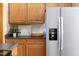 Bright kitchen featuring wooden cabinets and stainless steel refrigerator with water dispenser at 404 Denton St, Durham, NC 27713
