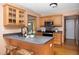 Open kitchen with a kitchen island and bar stool seating and stainless steel appliances at 404 Denton St, Durham, NC 27713