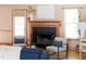 Cozy living room featuring a classic fireplace, hardwood floors, and comfortable seating arrangement with natural light at 404 Denton St, Durham, NC 27713