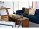 Stylish living room with a comfortable blue sofa, hardwood floors, and a modern coffee table setup at 404 Denton St, Durham, NC 27713