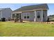 Backyard featuring a lawn with a view of the patio and the home's back facade at 404 Porterfield Dr, Youngsville, NC 27596