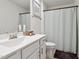 Clean bathroom featuring a white vanity, modern fixtures, and a shower/tub combination with a stylish curtain at 404 Porterfield Dr, Youngsville, NC 27596