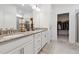 Elegant bathroom features double sinks, granite countertops, stylish fixtures, and a walk-in closet for ultimate convenience at 404 Porterfield Dr, Youngsville, NC 27596