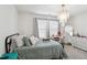 Bright bedroom featuring neutral tones, soft bedding, and a stylish chandelier at 404 Porterfield Dr, Youngsville, NC 27596