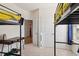 Bright bedroom showcasing black bunk beds, plush carpet, and a doorway leading to other living spaces at 404 Porterfield Dr, Youngsville, NC 27596
