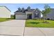 Two-story home with gray siding, manicured lawn, and a concrete driveway at 404 Porterfield Dr, Youngsville, NC 27596
