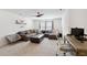 Spacious living room with a comfortable sectional, modern desk, and plush carpet perfect for relaxation or work at 404 Porterfield Dr, Youngsville, NC 27596