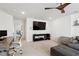 Inviting living room featuring a modern desk, comfortable seating, and a large TV perfect for relaxing and entertaining at 404 Porterfield Dr, Youngsville, NC 27596