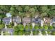 An aerial view captures houses and manicured yards, displaying neighborhood layout and green spaces at 404 Wanderview Ln, Holly Springs, NC 27540