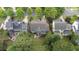 Beautiful aerial view of a home with a well-manicured lawn, patio, and mature trees in a desirable neighborhood at 404 Wanderview Ln, Holly Springs, NC 27540