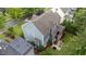 Aerial view of a charming home featuring a patio, screened in porch, solar panels and a well-manicured lawn, perfect for outdoor enjoyment at 404 Wanderview Ln, Holly Springs, NC 27540