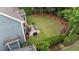 Expansive backyard featuring a well-maintained lawn, patio, and lush landscaping, providing an ideal space for outdoor activities at 404 Wanderview Ln, Holly Springs, NC 27540