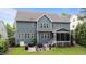 View of the back of the home highlighting a screened porch and patio seating area for outdoor enjoyment at 404 Wanderview Ln, Holly Springs, NC 27540