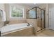 Elegant bathroom featuring a soaking tub and walk-in shower at 404 Wanderview Ln, Holly Springs, NC 27540