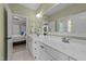 The bathroom features double sinks with white cabinets, a large mirror, and light green walls at 404 Wanderview Ln, Holly Springs, NC 27540