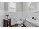 This bathroom boasts wainscoting, natural light, and hardwood flooring at 404 Wanderview Ln, Holly Springs, NC 27540