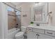 Bathroom featuring a shower/tub combo, white vanity, and earth-toned tile at 404 Wanderview Ln, Holly Springs, NC 27540